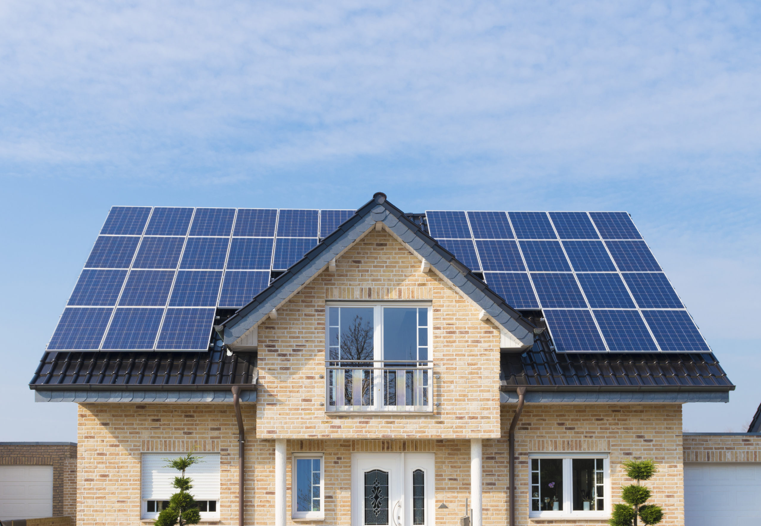 solar panels on roof Gronau, Germany - March 6, 2014: New house with solar panels on its roof. In Germany solar energy is heavily subsidized by the government
